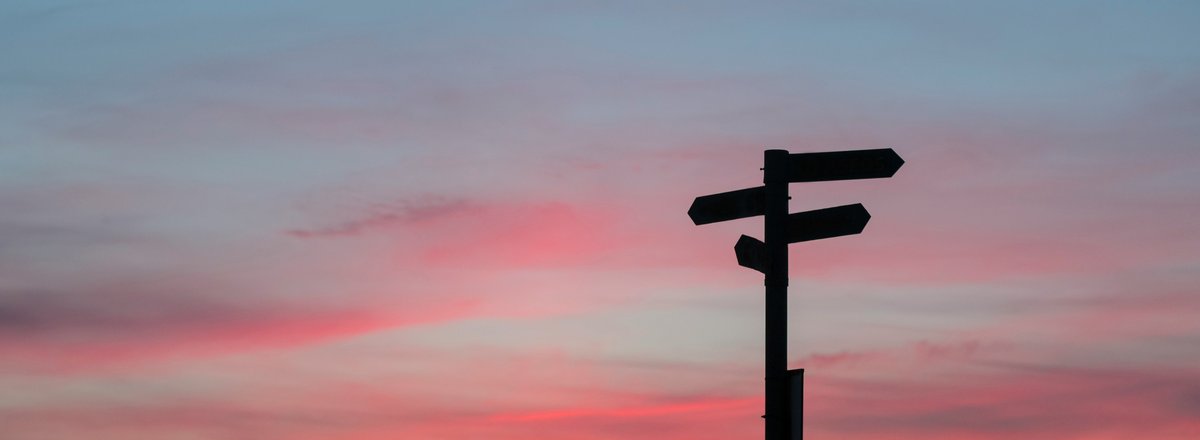 Decorative element: Signpost in front of the evening sky