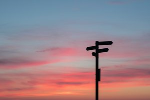 Decorative element: Signpost in front of the evening sky